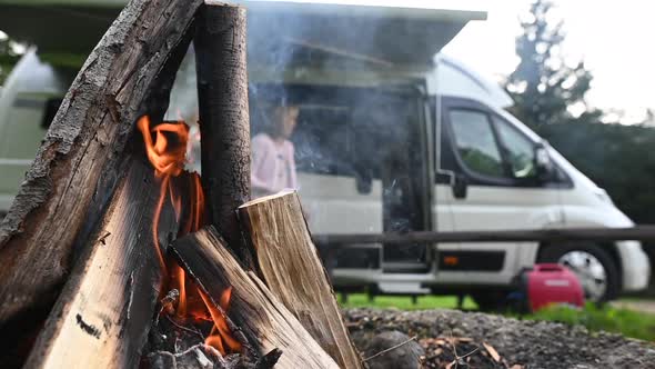 Motorhome Camper Van and Campfire on Campground Pitch