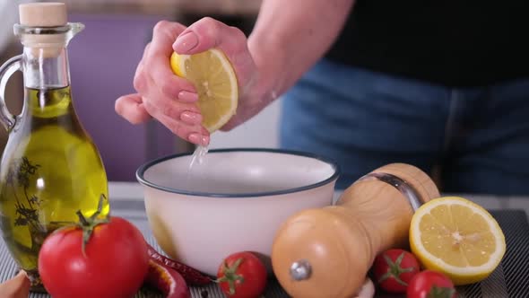 Squeezing Lemon Juice Into Bowl with Barbecue Sauce Ingredients Slow Motion