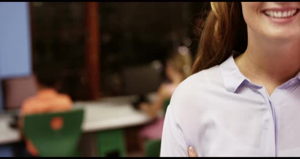 Portrait of teacher smiling in classroom