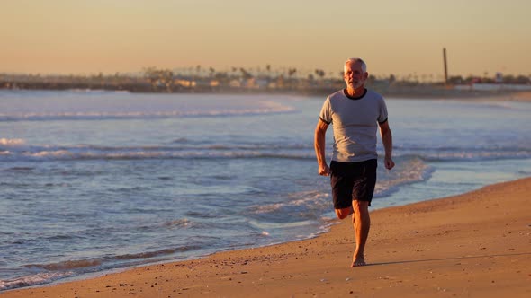 Senior Man Exercising At The  Beach