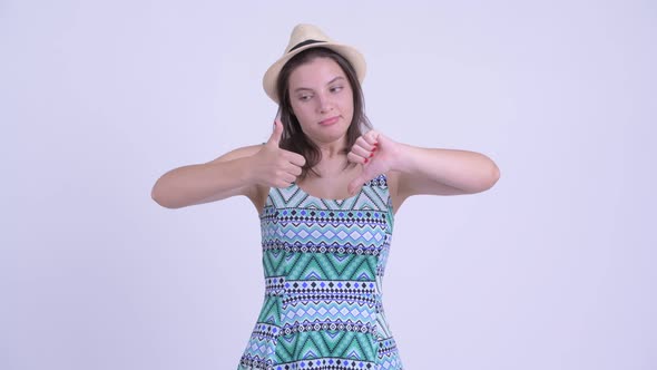 Confused Young Tourist Woman Choosing Between Thumbs Up and Thumbs Down