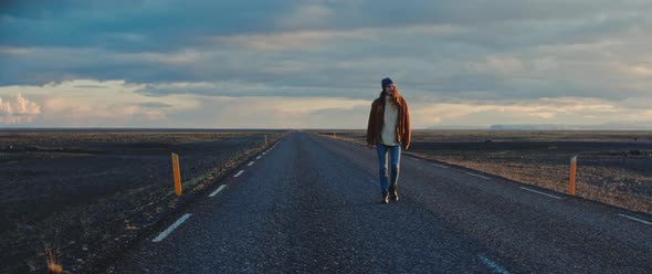 Person walks along empty road