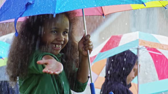 Laughing Little Girl Catching Raindrops