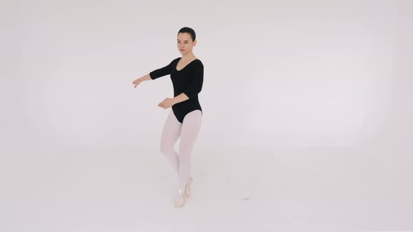 Woman Dancing Gracefully in Ballet Studio
