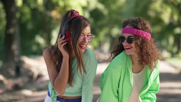 Medium Shot Portrait Two Retro Ladies in Sunglasses Laughing Standing in Summer Park in 1990s