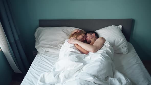 Sensual Couple Embracing in Bed