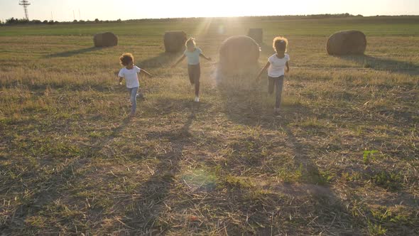 Cheerful Mixed Race Girls Running Across Field