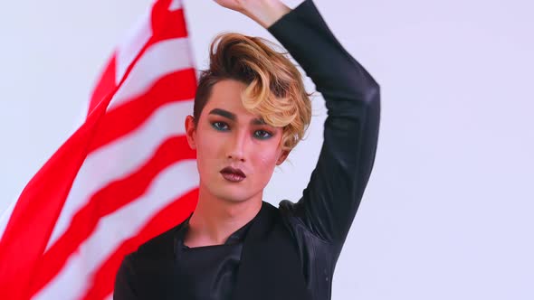 Closeup Portrait of a Young Man with a Lipstick Wrapped on American Flag White Background