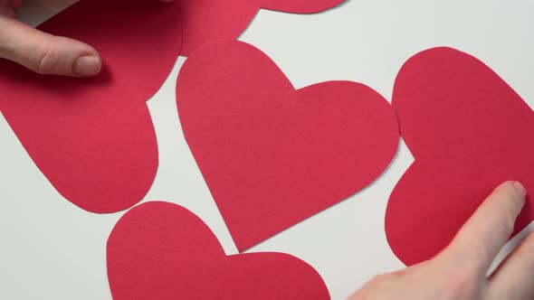 Hands Moving Red Heart Shape From Paper White Background