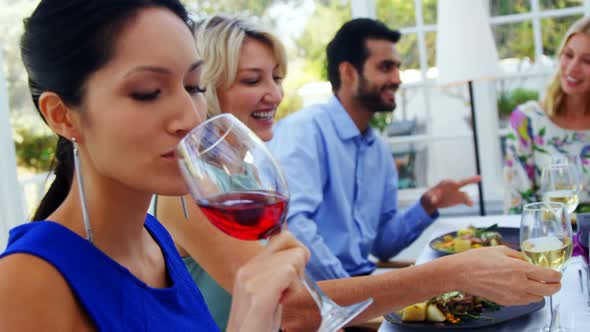 Woman having glass of red wine