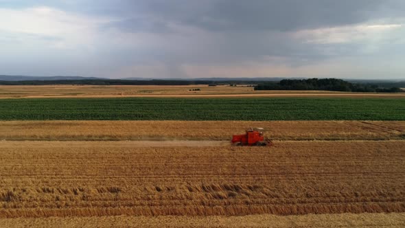 Drone view of modern combine harvester during harvesting 