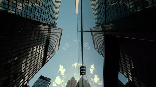 Bottom View of Pass By Several Skyscrapers in a Peaceful City Under the Cloudy Sky in Calm Day