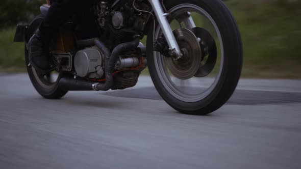 Motorcycle in the Middle of a Tight Road With the Glimpse of the Clear Skies
