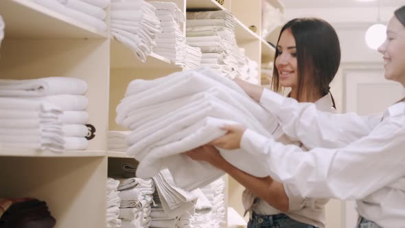 Young Lady Sorting Putting Clean Towels Shelf Laundry