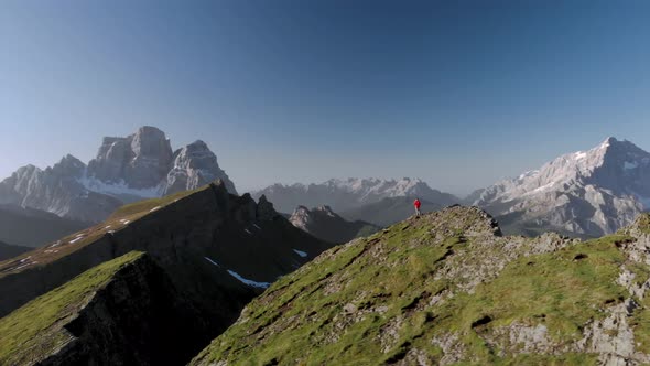 Aerial Spin Around Man Hiker In Front of Pelmo and Civetta Mountain in Dolomites Italy