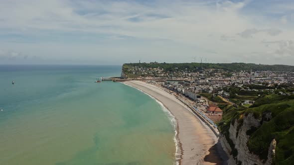 A Town Located on the Coast Among Sheer Cliffs with a Natural Arch