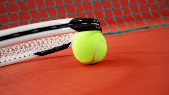 Racket arranged on tennis ball in court 4k