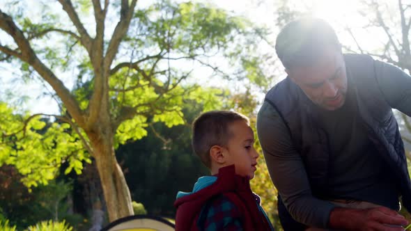 Father and son setting up a tent