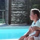 Mother and son hugging on lounger by pool - VideoHive Item for Sale