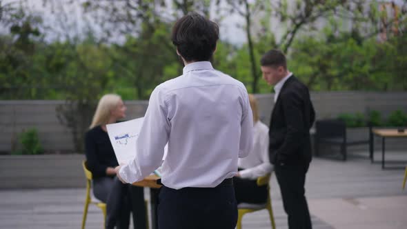 Live Camera Follows Confident Business Analyst Walking with Graph in Slow Motion to Colleagues on