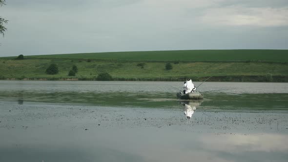 Man fishing on lake. Fisherman catching fish in lake or river water. Fishing on lake.