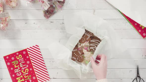 Flat lay. Step by step. Packaging homemade fudge and cookies into a Christmas gift box.