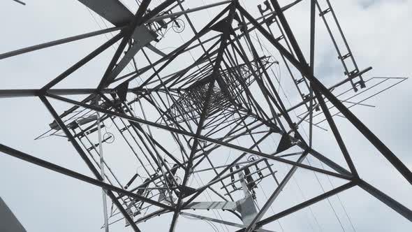 Huge Metal Highvoltage Tower with Electric Wires the Bottom View Up Slow Movement of a Video Camera