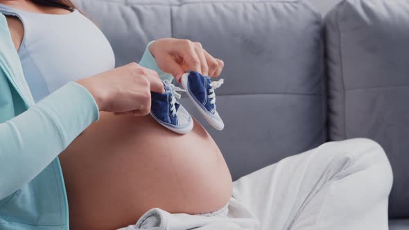 Young pregnant woman is resting at home and expecting a baby.