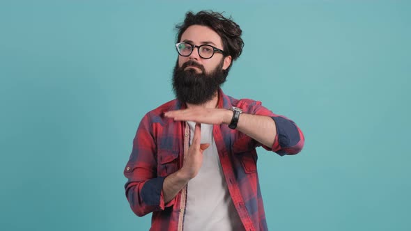 Portrait of a Bearded Man Making the Time Out Gesture, Asking for a Break.