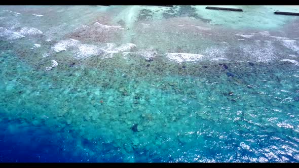 Aerial above scenery of relaxing coast beach break by blue sea with white sandy background of a picn