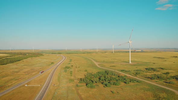 Windmills for Electric Power Production in the Meadow. Group of Windmills for Renewable Electric