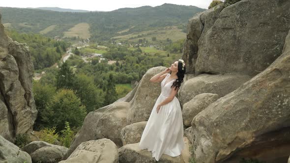 Beautiful and Lovely Bride Standing on the Mountain Hills. Woman in Love