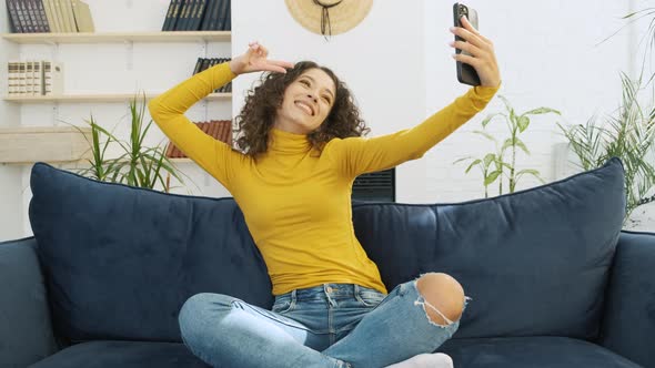 Pretty Woman Taking Selfie with Smartphone at Home
