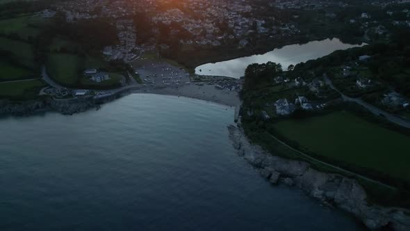 Aerial fly out of Swanpool beach and coast Falmouth Cornwall England UK