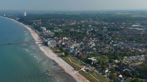 High Aerial Drone View of Sensational Summertime Tourist Beach in Scharbeutz Germany Dolly in Sunny