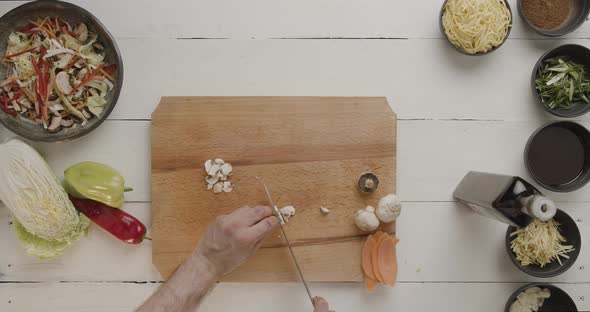 Male Chef Cuts Vegetables for Salat Tasty Food Ingredients Carrot and Mushrooms