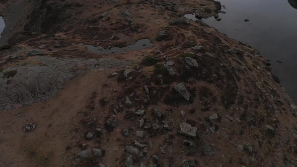 Rotation drone shot revealing Pic du Midi d'Ossau, Lac d' Ayous (French Pyrenees). Man walking throu