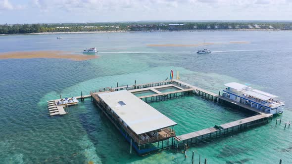 Aerial View Of Offshore Ocean Park In The Caribbean Sea With Tourist Boats Sailing In Summer. Travel