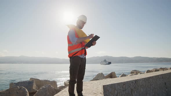 Engineer Takes Notes on a Clipboard