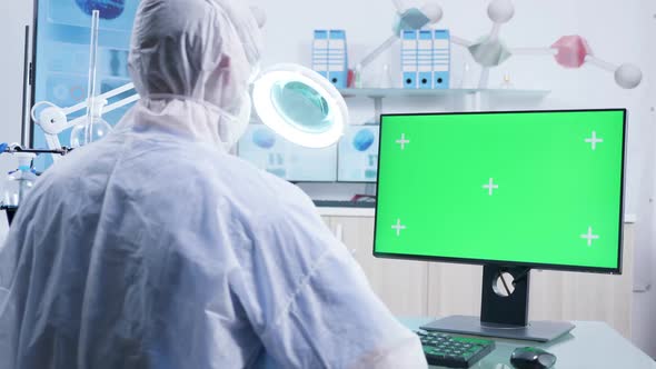 Zoom in Shot of Researcher Working with Green Screen Monitor