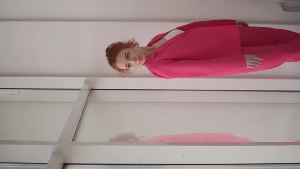 a Girl in a Pink Suit Dancing at the Window