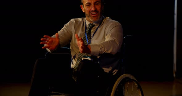 Mature Caucasian disabled businessman speaking in business seminar in auditorium 4k