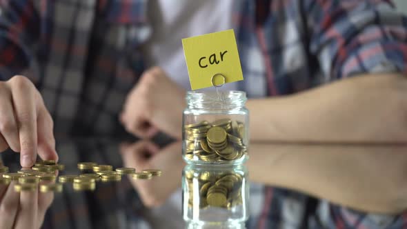 Car Word Written Above Glass Jar With Money, Savings for Maintenance, Insurance