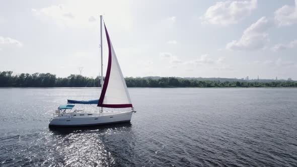 Closeup Aerial View of a Sailing Boat on the River