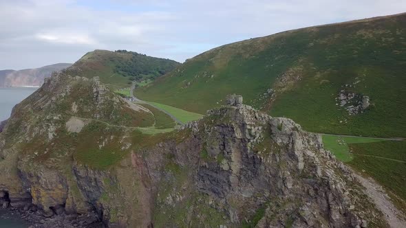 Wide aerial panning and tracking from right to left around the Valley of Rocks, near Lynton, Devon.