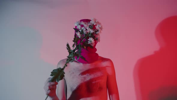 Anonymous Shirtless Man in Balaclava with Flowers