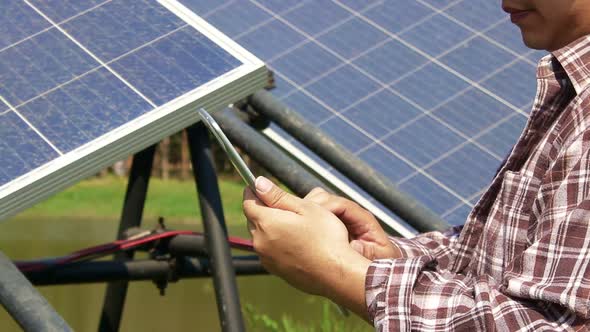 farming man holding a tablet Used to control solar panels