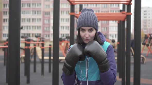Portrait of a Boxer Woman in Boxing Gloves on the Streetslow Mo