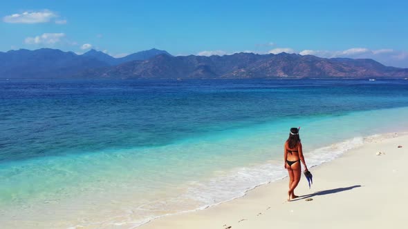 Women happy and smiling on beautiful coastline beach journey by blue water and clean sand background