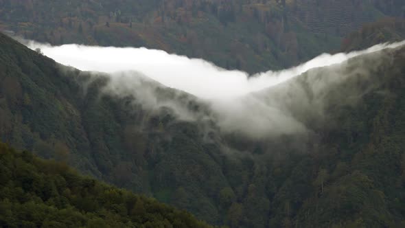 Cloud Eaterfall Flowing Down the Mountain Ridge
